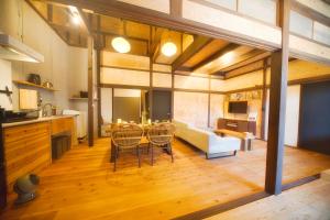 a kitchen and dining room with a table and chairs at 御宿Shogun in Kurume