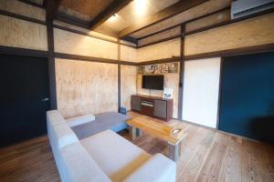 a living room with a couch and a table at 御宿Shogun in Kurume