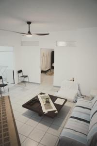 a room with a couch and a table and chairs at Ξενώνας OLEAVIA in Kalamata