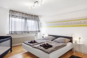 a bedroom with a large bed with two towels on it at Ferienwohnung Windradblick in Schonach