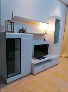 a white entertainment center with a flat screen tv at Zenitude in Casablanca