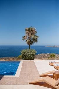 a swimming pool with a view of the ocean at Villa Jamila by Cura Villas Collection in Kalathas