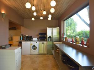 a kitchen with a refrigerator and a washer and dryer at Luxury Villa with Sauna in Francorchamps