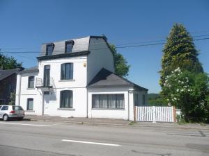 a white house on the side of a street at Luxury Villa with Sauna in Francorchamps