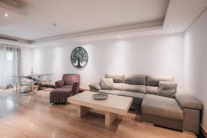 a living room with a couch and a coffee table at Luxury 2 bedrooms, Private Heated Pool - EHHouse in Estepona
