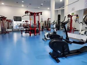 a gym with cardio equipment on a blue floor at Luxury 2 bedrooms, Private Heated Pool - EHHouse in Estepona
