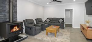 a living room with a couch and a fireplace at Buzzin' in Hay