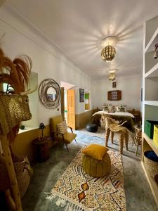 a living room with a room with a table and a room at Kasbah Habibi petit déjeuner inclus in Lalla Takerkoust