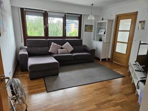 a living room with a couch and a chair at Astigarraga Sagarra by RUVA in Astigarraga