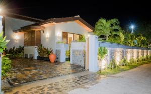 a house with a gate in front of it at night at 701 Mawella Villa in Mawella