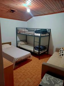a room with two bunk beds and a couch at Alojamento Excalibur in Meda +12 photos