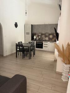 a kitchen with a table and chairs in a room at Perla Marina in Marina di Sibari