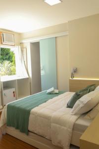 a bedroom with a large bed with a window at Hotel Esperança AdultOnly in Rio de Janeiro