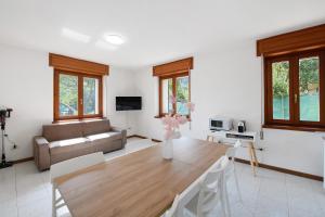 a living room with a table and a couch at Villa Arcadia Apartments in Vobarno