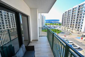 a balcony with a view of a city at Yas Island 2BR | Pool | Near Ferrari World & Mall in Abu Dhabi