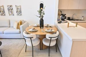 a kitchen with a table and chairs in a kitchen at Chic Family 2br, Canal Views! Near Ferrari World in Abu Dhabi