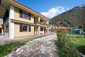 a house with a playground in the background at Villa Arcadia Apartments in Vobarno