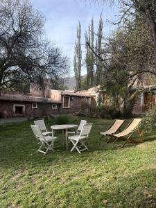 a group of chairs and a table in a yard at Quinta La Paceña in Tilcara +42 photos
