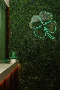 a green wall with a green clover painted on it at Hotel Esperança AdultOnly in Rio de Janeiro