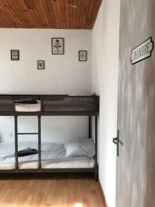 a room with two bunk beds and a door at Maison 8 pers St Lary 7 min et Val Louron 10 min in Azet