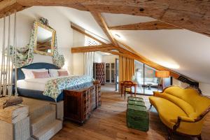 a bedroom with a bed and a chair at Castel Sallegg Suites Adults only in Caldaro +72 photos