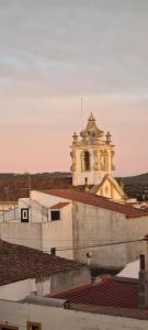 a building with a clock tower on top of a roof at Pérola Azul de Alter do Chão in Alter do Chão +5 photos