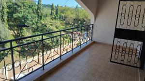a balcony with a view of a forest at Serena Beach Road Apartment in Mombasa