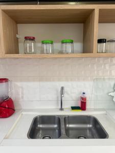 a kitchen counter with a sink in a kitchen at Casa da Anita in Boa Vista +32 photos