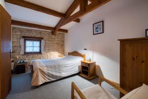a bedroom with a bed and a table and a window at La musardière in Saint-Germain-du-Seudre +22 photos