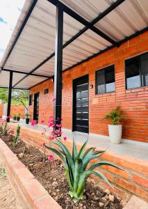 a house with an orange brick building with a porch at Almi Apart in Filadelfia