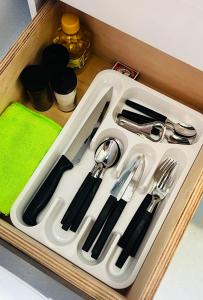 a white tray with utensils in a drawer at Almi Apart in Filadelfia +10 photos