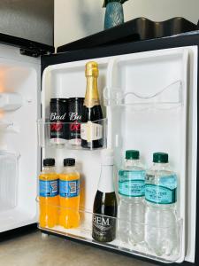an open refrigerator filled with lots of bottles of drinks at Almi Apart in Filadelfia