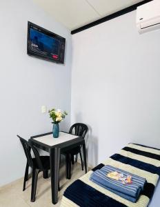 a room with a table and a tv on the wall at Almi Apart in Filadelfia