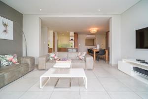 a living room with a couch and a table at 17 Tamboti, Simbithi Eco Estate in Ballito