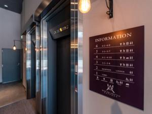 a sign on the wall of a building at リブマックスホステルズ札幌すすきの in Sapporo