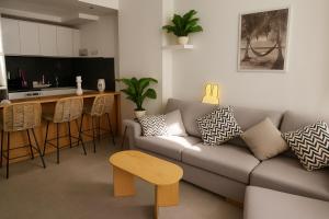 a living room with a couch and a kitchen at Sunny Escape 1BR with Pool Access in Hurghada