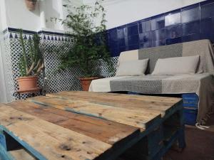 a room with two beds and a wooden table at Apartamento Bidaya in Ronda