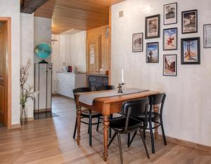 a kitchen and dining room with a wooden table and chairs at Cute chalet in Kandersteg in Kandersteg
