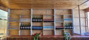 a wall with bottles of wine on it at Dilovar's Homestay  +25 photos