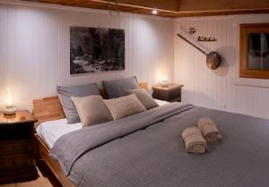 a bedroom with a large bed with two towels on it at Bed&Museum Alpine Nomads in Chalais