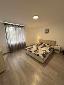 a bedroom with a bed with a comforter on it at Apartman MATEA in Pirot