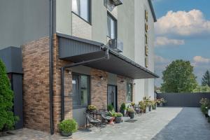 a brick building with a balcony and a patio at Seven Hills Hotel in Stoyanka