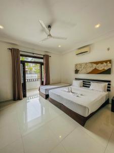 Postel nebo postele na pokoji v ubytování Sunrise Palace Negombo