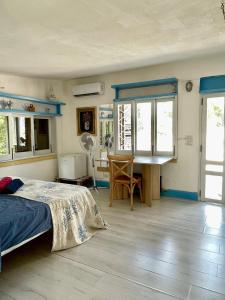 a bedroom with a bed and a desk in it at La Terrazza on Acquaviva in Marittima