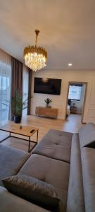 a living room with a couch and a chandelier at Žvejų gatvė 1 Telšiai in Telšiai