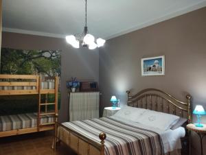 a bedroom with a bed and a crib at Ca' d'la nona casa con giardino in Agliano Terme