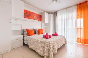 a bedroom with a bed with pink pillows on it at Fabulous two bedroom apartment near las Vistas Beach in Los Cristianos in Arona +12 photos