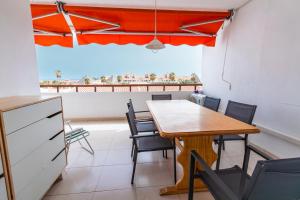 a dining room with a table and chairs at Fabulous two bedroom apartment near las Vistas Beach in Los Cristianos in Arona