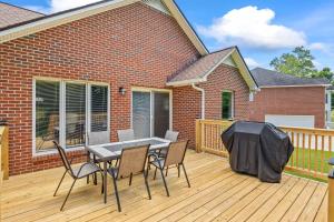 a patio with a table and chairs on a deck at Cookeville Family Retreat 3BR Home with Yard Close to TTU & Town in Cookeville