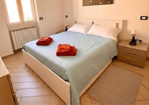 a bedroom with a large bed with two red towels on it at Casa Samu in Cornaredo